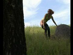 Nudist Kitty Gets On Top Of A Rock To Make Water